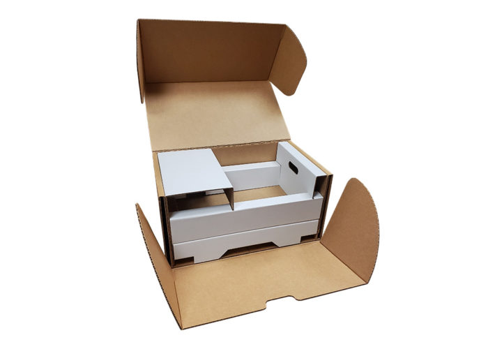 A big industrial box containing a two tiered insert designed to protect electronics
